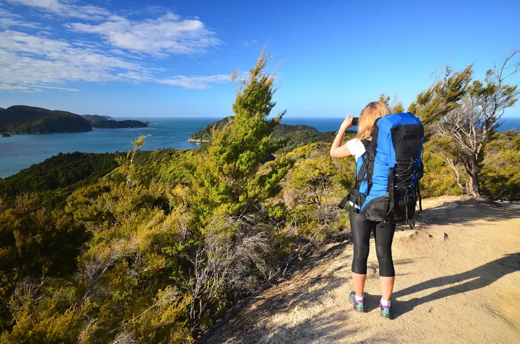 tourist looking at the view of abel tasman from top