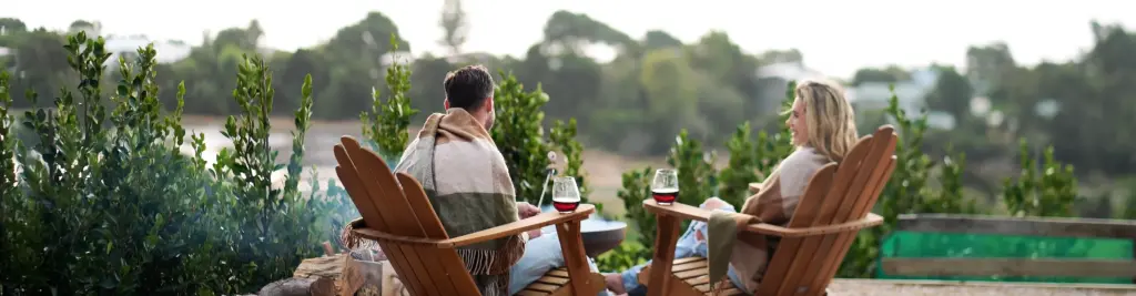 couple drink wine at drift off grid eco luxury glamping tent golden bay new zealand