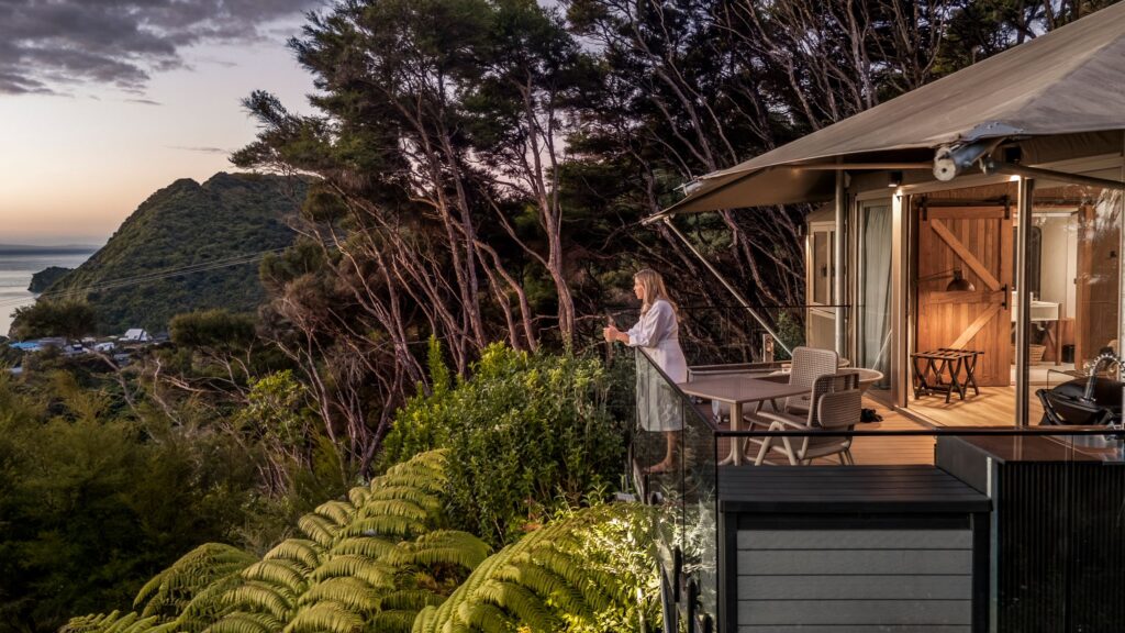 Exterior of Kānuka luxury off-grid accommodation in Golden Bay, surrounded by native bush near Tata Beach.